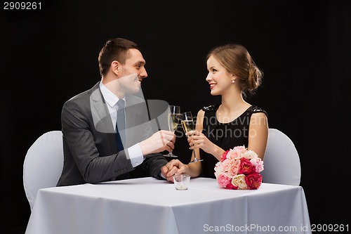 Image of couple with glasses of champagne at restaurant