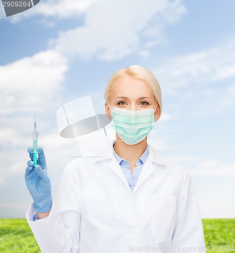 Image of doctor in mask holding syringe with injection