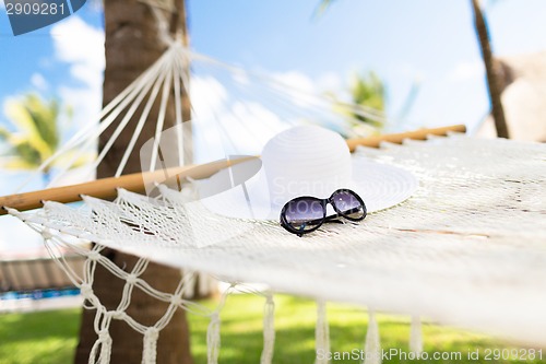 Image of picture of hammock with white hat and sunglasses