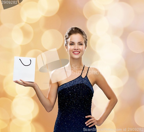 Image of smiling woman with white blank shopping bag