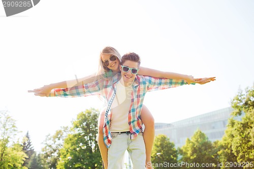 Image of smiling couple having fun in park