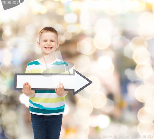 Image of smiling little boy with blank arrow pointing right