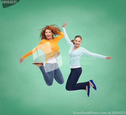 Image of smiling young women jumping in air