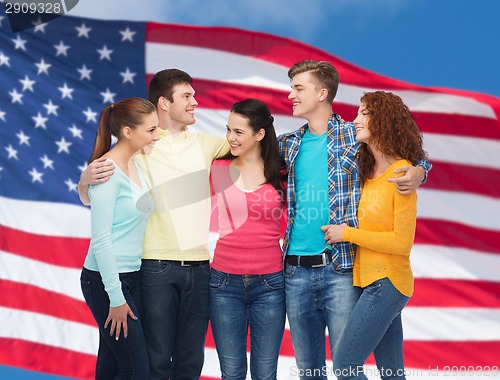 Image of group of smiling teenagers over american flag