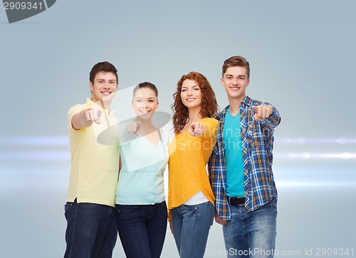 Image of group of smiling teenagers pointing fingers on you