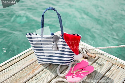 Image of close up of beach accessories and santa helper hat