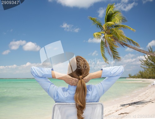 Image of businesswoman sitting on chair from back