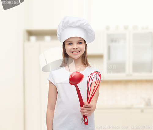 Image of smiling girl in cook hat with ladle and whisk