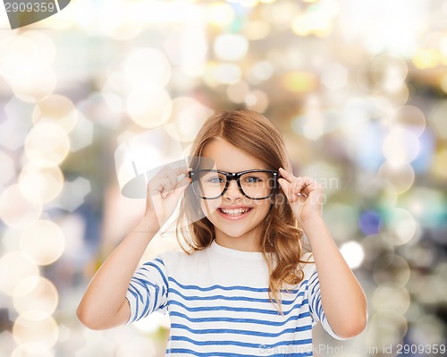 Image of smiling cute little girl with black eyeglasses