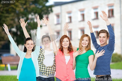 Image of group of smiling students waving hands