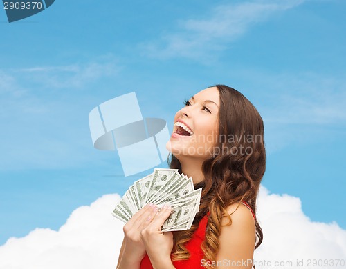 Image of woman in red dress with us dollar money