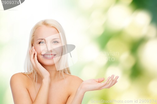 Image of smiling woman holding imaginary lotion jar