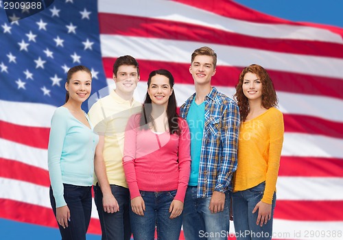 Image of group of smiling teenagers over american flag