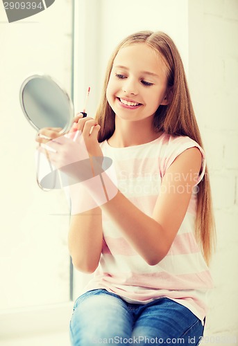 Image of teenage girl with lip gloss and mirror