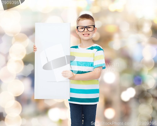 Image of smiling boy in eyeglasses with white blank board