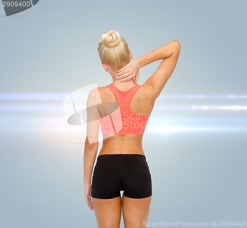 Image of sporty woman touching her neck