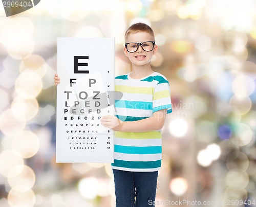 Image of smiling boy in eyeglasses with white blank board