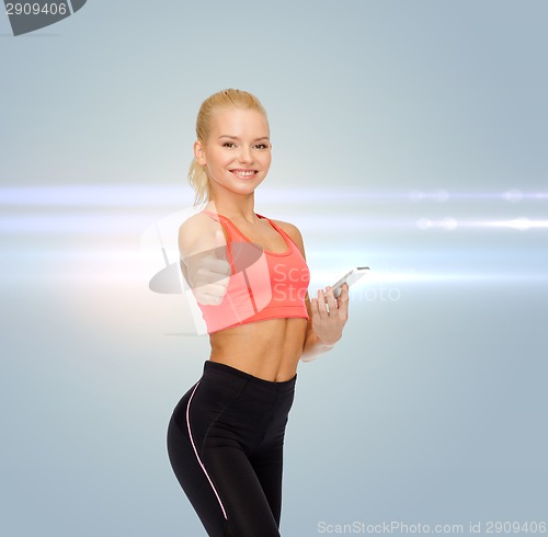 Image of smiling sporty woman with smartphone