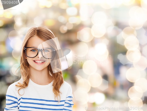 Image of smiling cute little girl with black eyeglasses