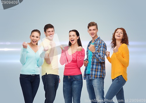 Image of group of smiling teenagers showing triumph gesture