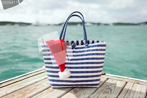 Image of close up of beach bag and santa helper hat