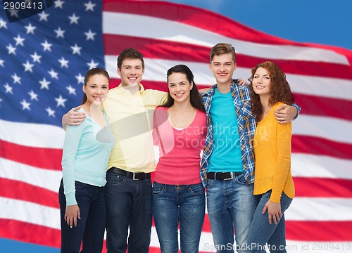Image of group of smiling teenagers over american flag