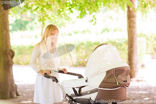 Image of happy mother with stroller in park