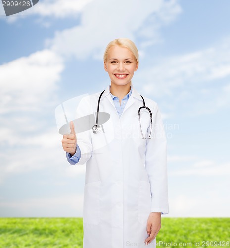 Image of smiling female doctor showing thumbs up