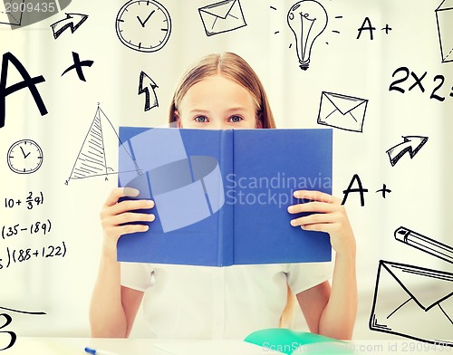 Image of girl studying and reading book at school