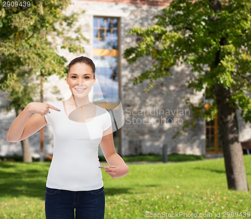 Image of smiling young woman in blank white t-shirt