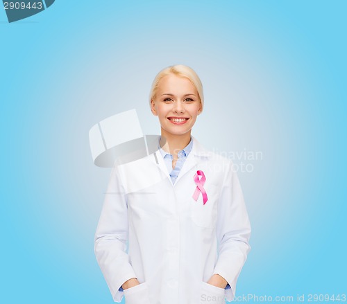 Image of smiling female doctor with cancer awareness ribbon