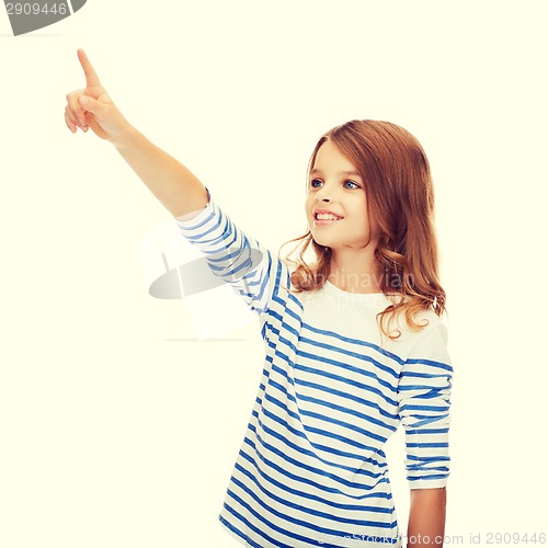 Image of smiling girl pointing at virtual screen