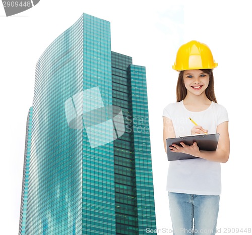 Image of smiling little girl in hardhat with clipboard