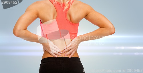 Image of close up of sporty woman touching her back