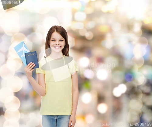 Image of smiling little girl with ticket and passport