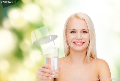 Image of young smiling woman with glass of water