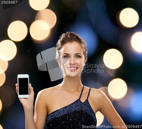 Image of smiling woman in evening dress with smartphone