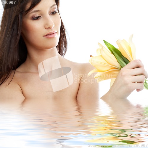 Image of happy brunette with yellow lily flowers in water #2