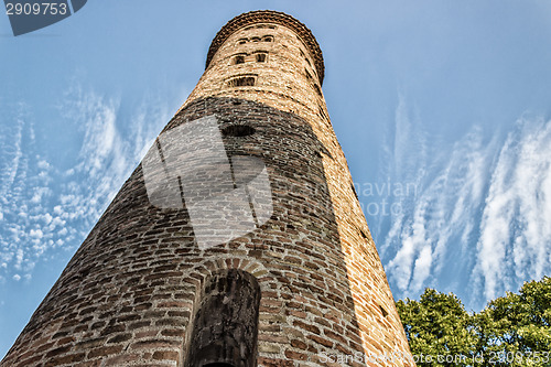 Image of Romanesque cylindrical bell tower of countryside church