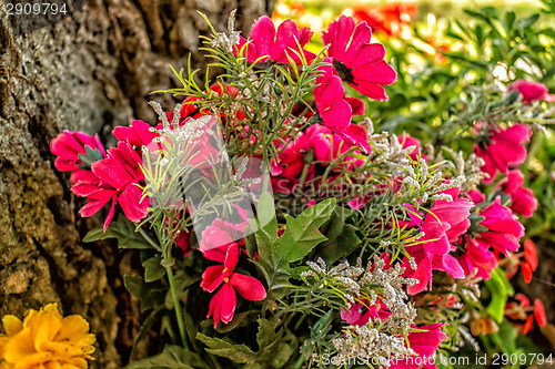 Image of Votive flowers under a tree