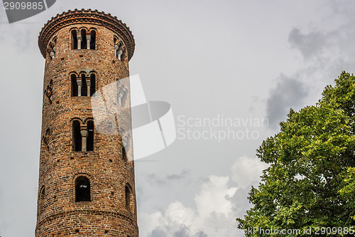 Image of Romanesque cylindrical bell tower of countryside church