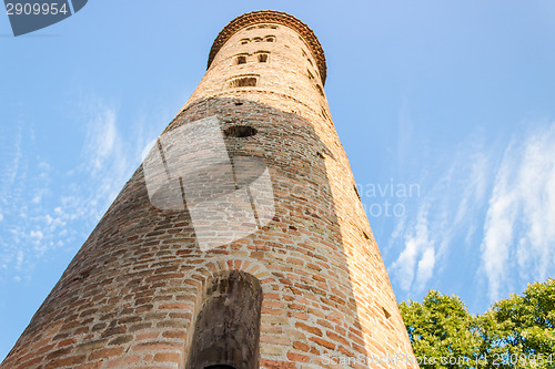 Image of Romanesque cylindrical bell tower of countryside church