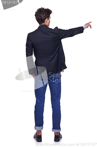 Image of Young man pointing, back view