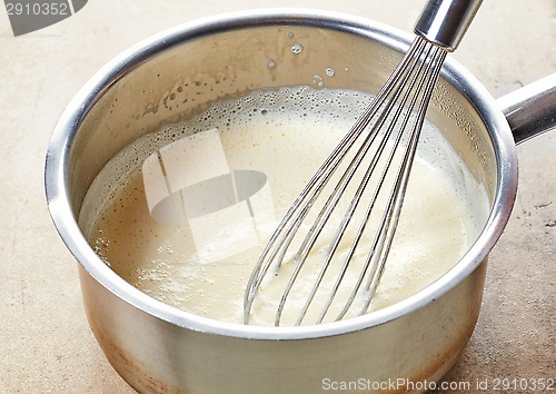 Image of making vanilla sauce in a pot 