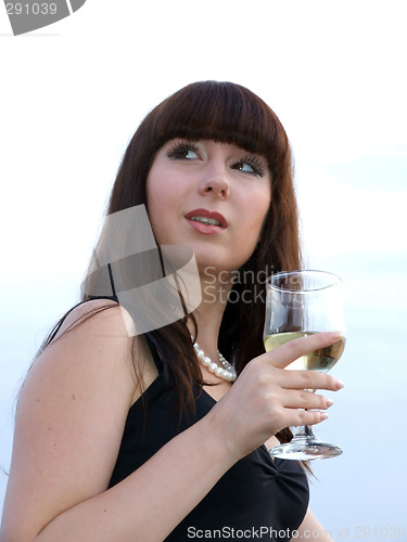 Image of The girl with a glass of white wine