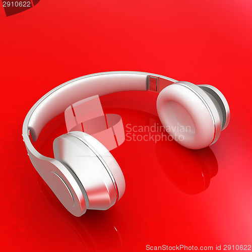 Image of White headphones isolated on a red background 