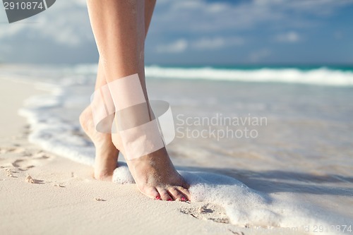 Image of closeup of woman legs on sea shore