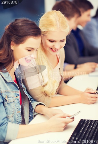 Image of students with computer monitor and smartphones