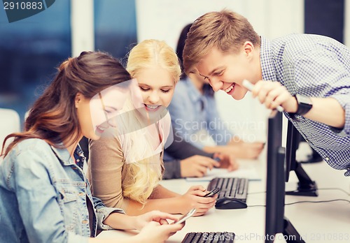 Image of students with computer monitor and smartphones