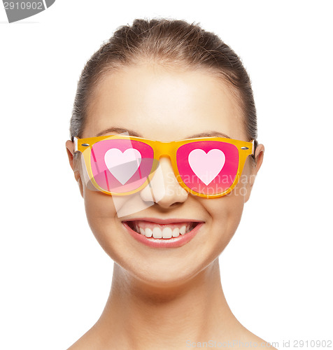 Image of smiling teenage girl in pink sunglasses